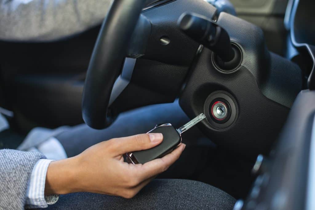 Personne sur le point d'insérer une clé sur le contact pour démarrer une voiture